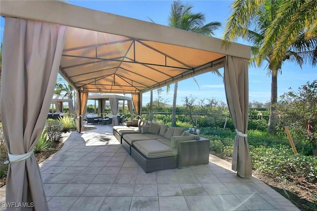 view of patio featuring an outdoor living space and a gazebo