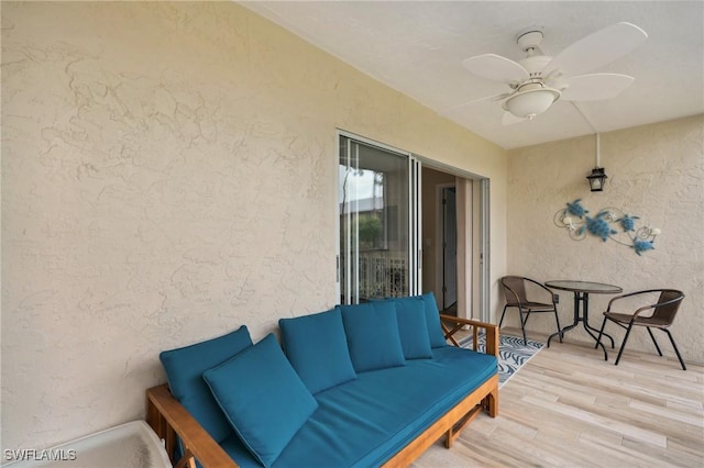 deck with ceiling fan and an outdoor living space