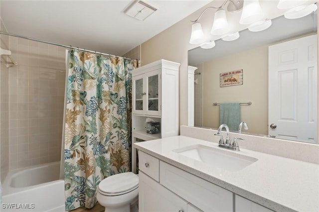 full bathroom with toilet, shower / bath combo, vanity, and visible vents