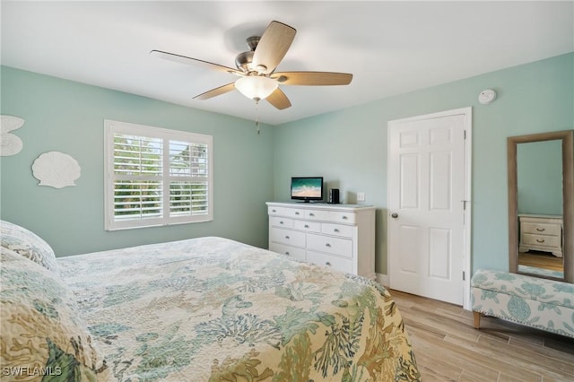 bedroom with light wood-style flooring and a ceiling fan