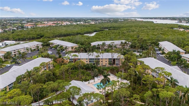 birds eye view of property with a water view and a view of trees