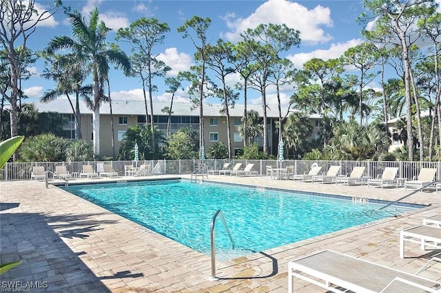 pool featuring fence and a patio