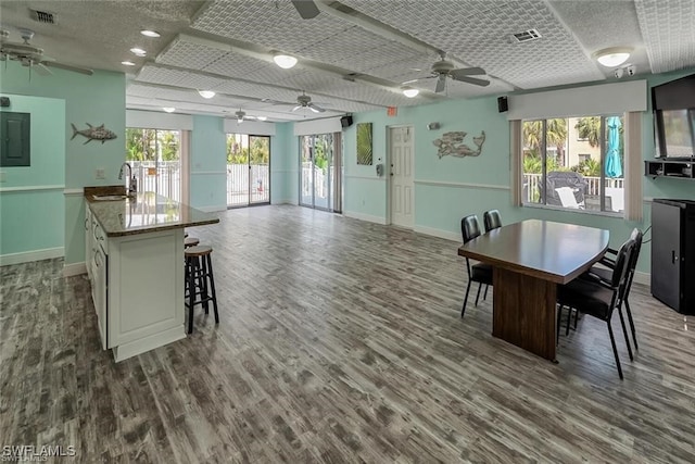 dining room featuring a healthy amount of sunlight, visible vents, and wood finished floors