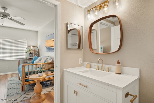 bathroom featuring hardwood / wood-style floors, ceiling fan, and vanity