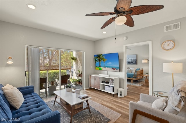 living room featuring hardwood / wood-style floors and ceiling fan