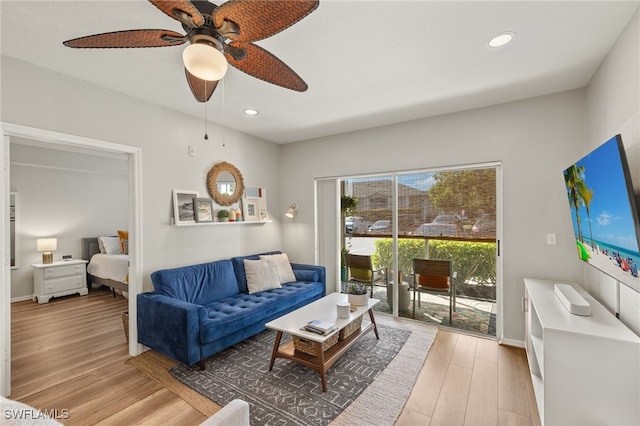 living room with ceiling fan and light hardwood / wood-style floors