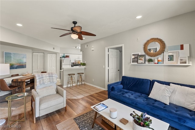 living room with ceiling fan and wood-type flooring