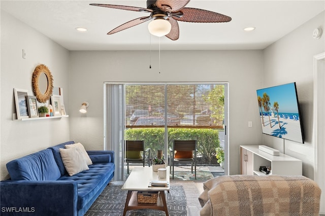 living room with ceiling fan and a healthy amount of sunlight