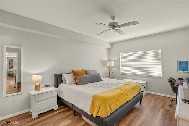 bedroom with hardwood / wood-style floors and ceiling fan