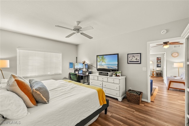 bedroom with ceiling fan and hardwood / wood-style flooring