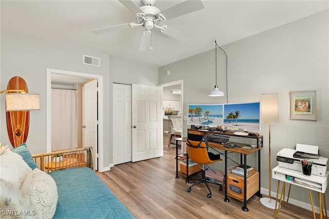 office with ceiling fan and light hardwood / wood-style floors