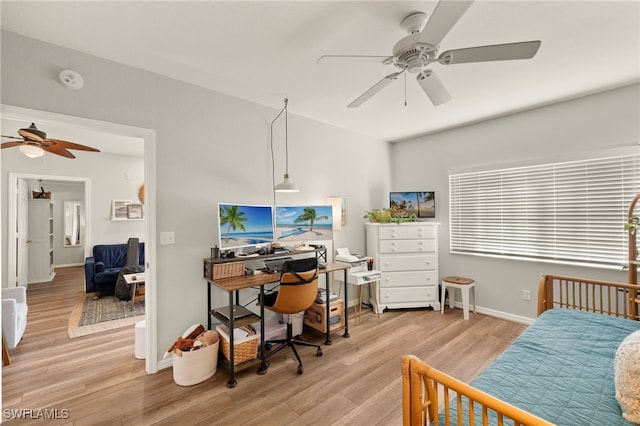 bedroom with light hardwood / wood-style floors and ceiling fan