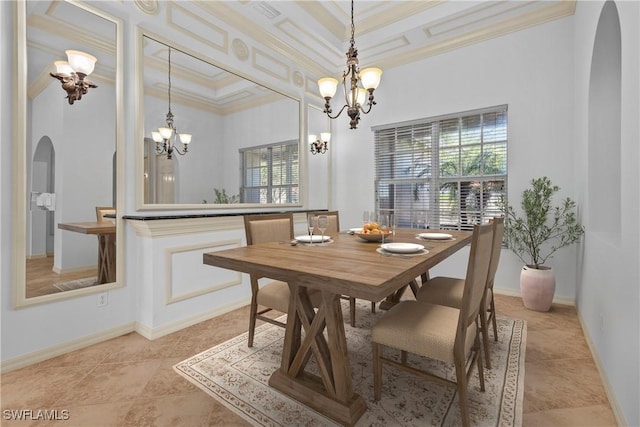 tiled dining room featuring a raised ceiling, an inviting chandelier, and crown molding