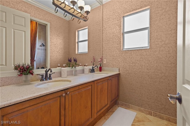 bathroom with crown molding, tile patterned flooring, and vanity