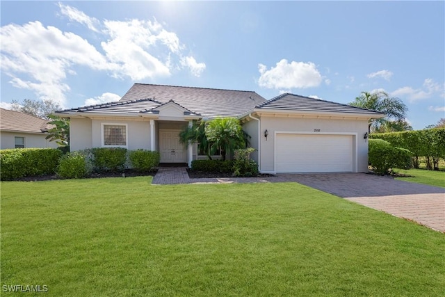 single story home featuring a garage and a front lawn