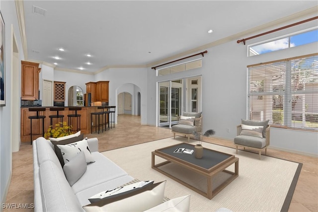 living room with crown molding and light tile patterned floors