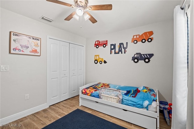 bedroom featuring ceiling fan, a closet, and wood-type flooring