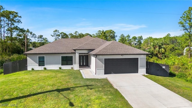 view of front of home featuring a garage and a front lawn