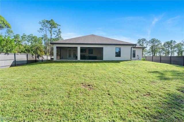 back of house featuring a lawn