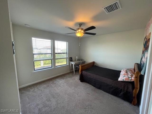 bedroom with ceiling fan and light carpet