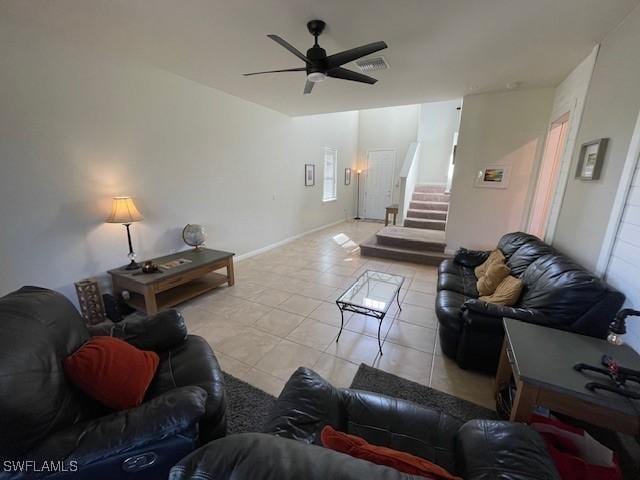 living room featuring light tile patterned floors and ceiling fan