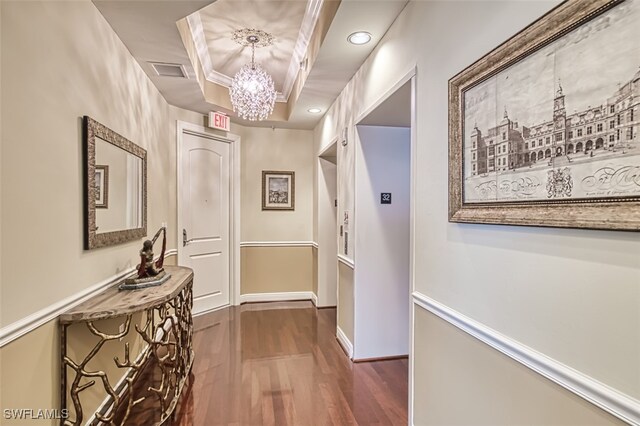 2104 W 1st St Unit 3204, Fort Myers, FL 33901 - corridor featuring an inviting chandelier, a raised ceiling, dark wood finished floors, baseboards, and visible vents