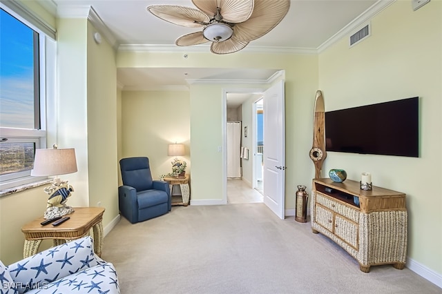 sitting room featuring ceiling fan, light colored carpet, and ornamental molding