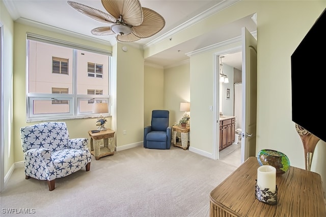 sitting room featuring light carpet, a healthy amount of sunlight, ceiling fan, and crown molding