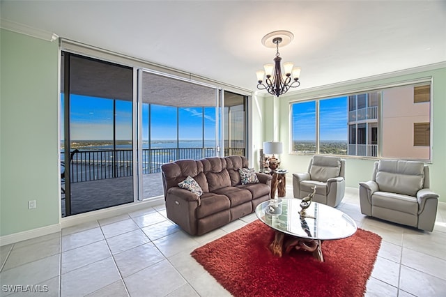 tiled living room with a notable chandelier, a water view, and crown molding