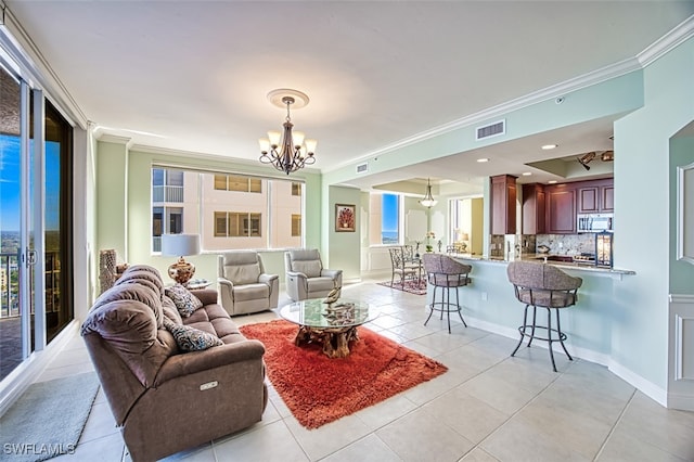 living room featuring a notable chandelier, light tile patterned floors, and crown molding