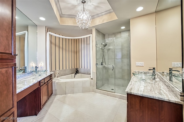 bathroom featuring an inviting chandelier, a raised ceiling, tile patterned flooring, vanity, and independent shower and bath