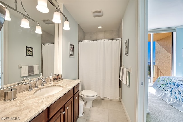 bathroom featuring toilet, vanity, tile patterned floors, and walk in shower