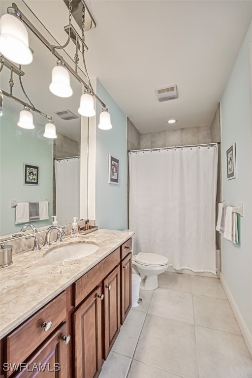 bathroom featuring tile patterned flooring, vanity, toilet, and curtained shower