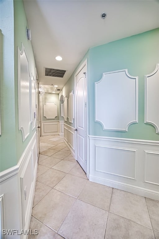 corridor featuring light tile patterned flooring