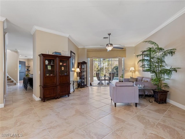 living room with ceiling fan and ornamental molding