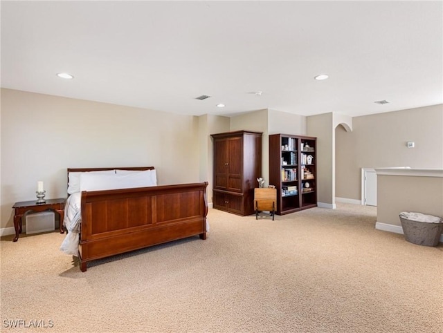 bedroom featuring light carpet