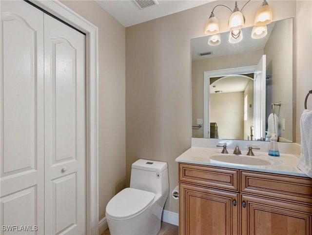 bathroom featuring vanity and toilet