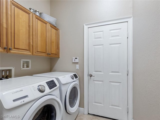 washroom with cabinets and separate washer and dryer