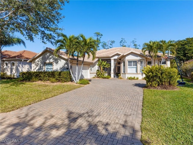20838 Torre Del Lago St, Estero, FL 33928 - ranch-style home with decorative driveway, a garage, stucco siding, a front lawn, and a tiled roof