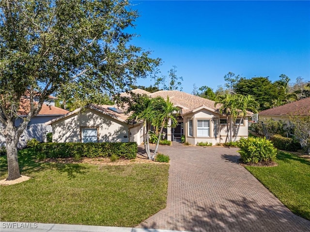 20838 Torre Del Lago St, Estero, FL 33928 - ranch-style home featuring decorative driveway, a front yard, stucco siding, and a tile roof