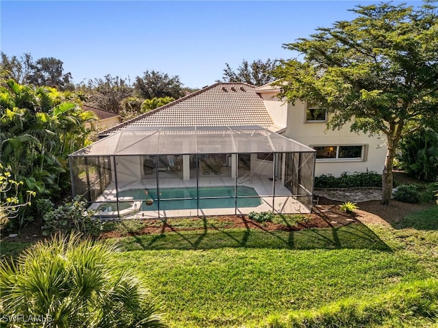 view of swimming pool with a yard and a lanai