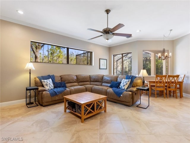 living room featuring ceiling fan with notable chandelier, a healthy amount of sunlight, and ornamental molding