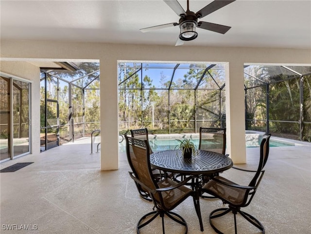 sunroom / solarium featuring ceiling fan and a swimming pool