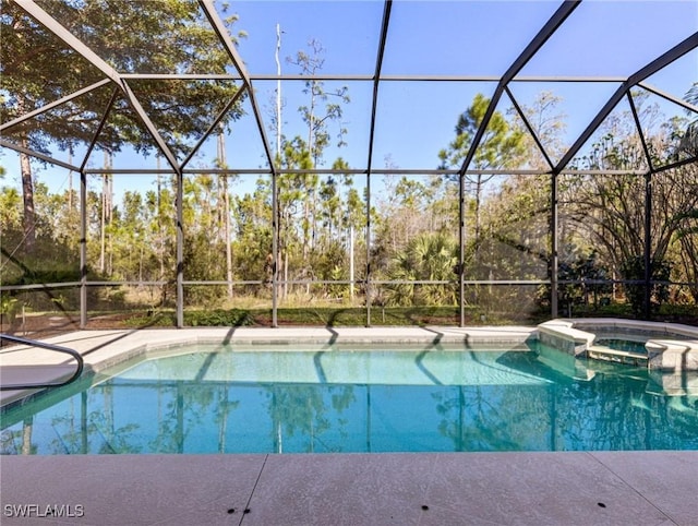 view of swimming pool with a lanai and an in ground hot tub