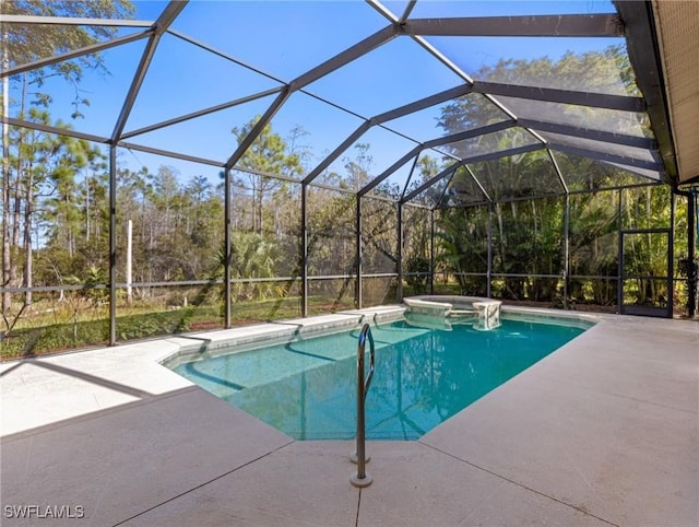 view of swimming pool with glass enclosure, an in ground hot tub, and a patio