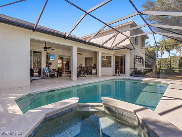 view of pool with ceiling fan, a lanai, a patio, and an in ground hot tub