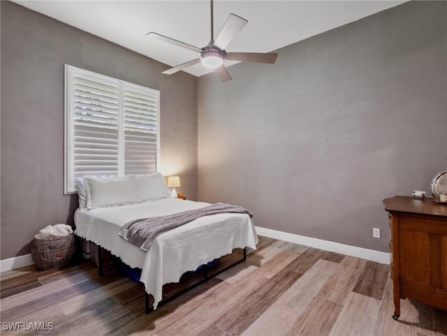 bedroom with ceiling fan and light hardwood / wood-style flooring