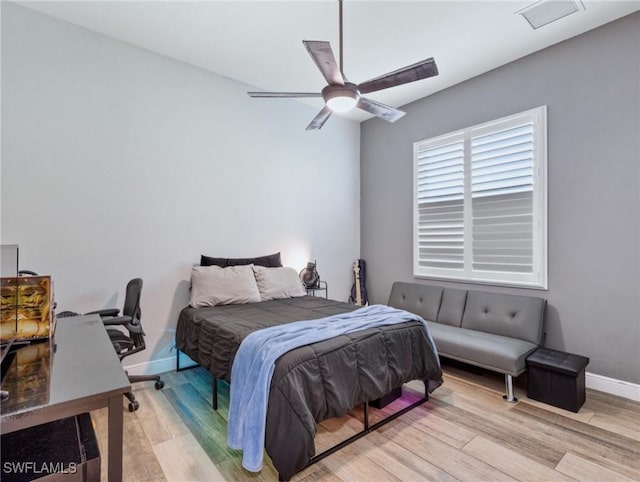 bedroom with ceiling fan and light hardwood / wood-style floors