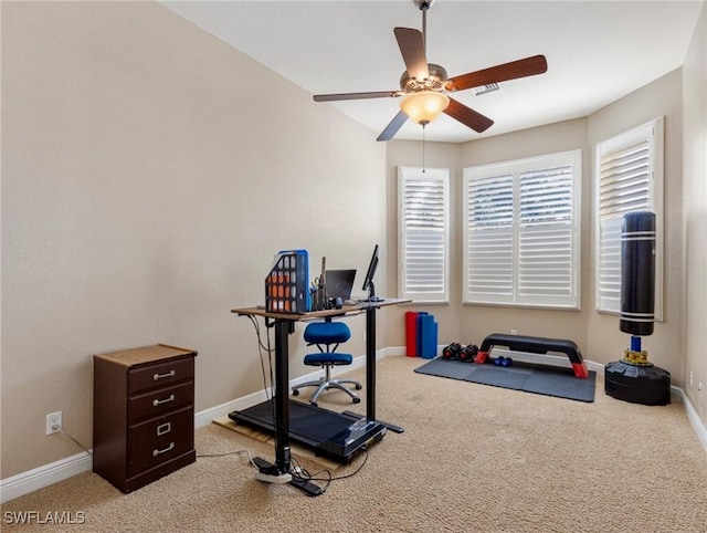 workout room with light colored carpet and ceiling fan