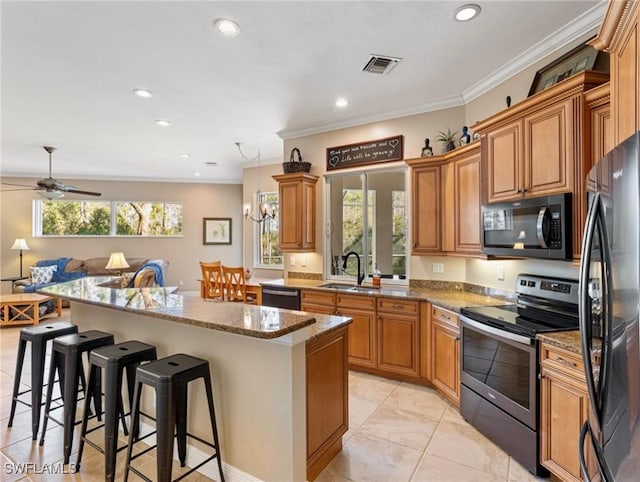 kitchen with dishwasher, sink, refrigerator, electric stove, and a kitchen island